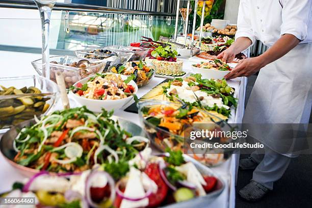 waiter serving a buffet table - buffet stockfoto's en -beelden