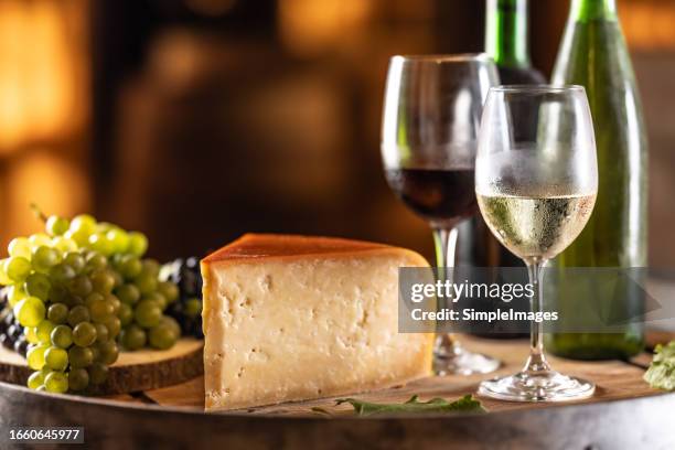 white and red wine with grapes and cheese on a wooden barrel in a wine archive cellar. concept of winery and grape products. concept of wine production. - czech republic wine stock pictures, royalty-free photos & images