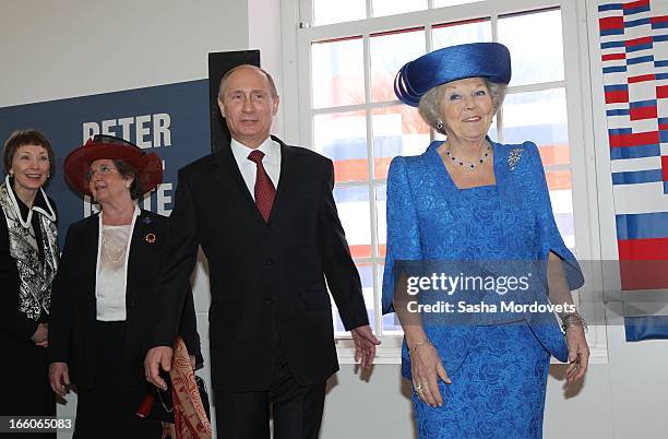 Dutch Queen Beatrix of the Netherlands meets Russian President Vladimir Putin as they unveil a plaque during their visit at the Hermitage Museum...