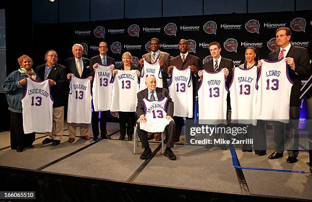 The members and representatives of the 2013 Naismith Memorial Basketball Hall of Fame class, : Edwin and Nikki Henderson hold the jersey of E.B....