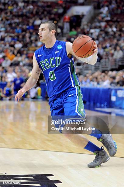 Brett Comer of the Florida Gulf Coast Eagles dribbles the ball during the second round of the 2013 NCAA Men's Basketball Tournament game against the...