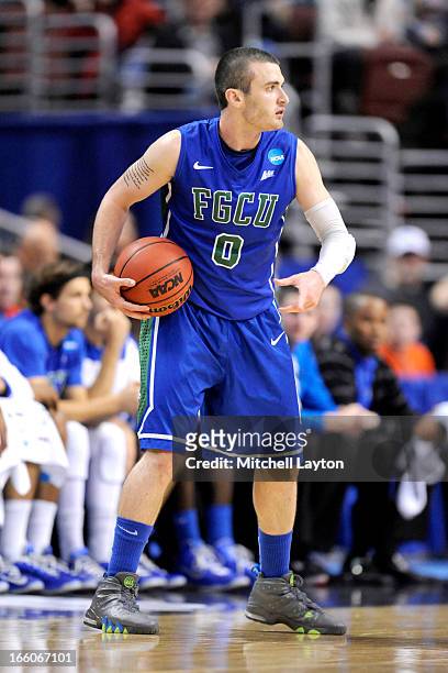 Brett Comer of the Florida Gulf Coast Eagles looks to pass the ball during the second round of the 2013 NCAA Men's Basketball Tournament game against...