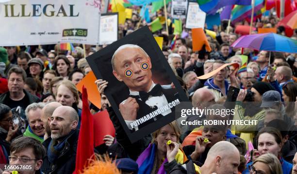 Over 1,000 people protest against Russian President Vladimir Putin's visit to Amsterdam on April 8 with rainbow flags flying at half-mast around the...