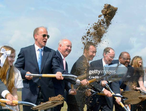 European Aeronautic Defence and Space Company CEO Tom Enders, gets into the spirt of a ground breaking ceremony by tossing dirt in the air for an...