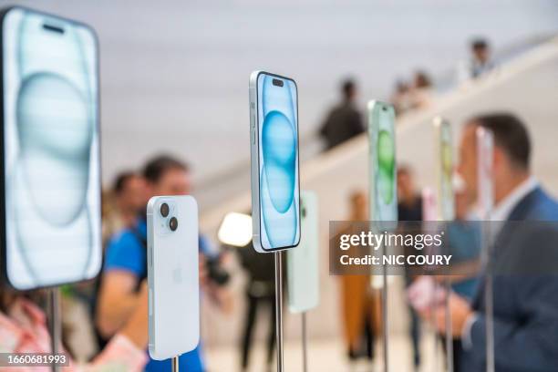 The new Apple iPhone 15, with EU ordered USB-C charger, is displayed amongst other new products during a launch event at Apple Park in Cupertino,...