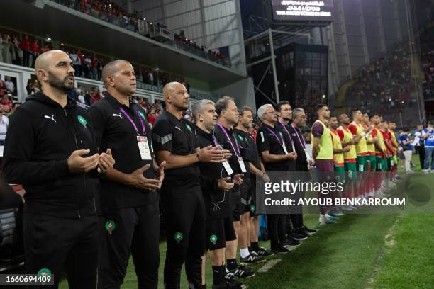 Moroccan players and coaching staff stand for a moment of silence for the victims of the Moroccan earthquake ahead of the international friendly...