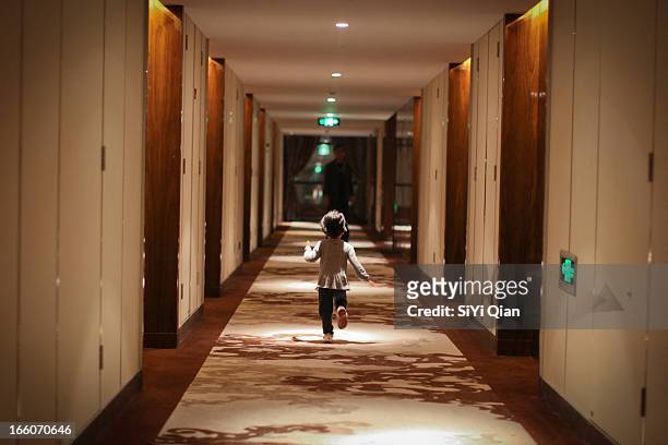 child running in the hotel corridor - kids hotel bildbanksfoton och bilder