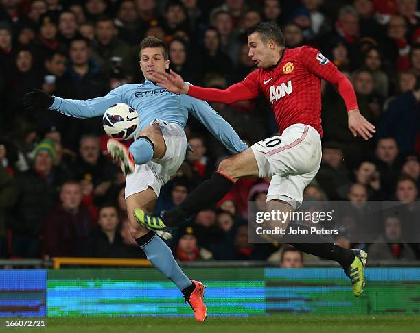 Robin van Persie of Manchester United in action with Matija Nastasic of Manchester City during the Barclays Premier League match between Manchester...