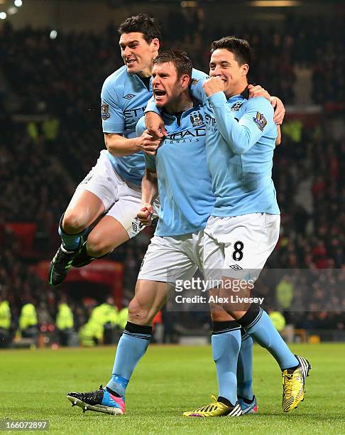 James Milner of Manchester City celebrates with his team-mates Gareth Barry and Samir Nasri after scoring the opening goal during the Barclays...