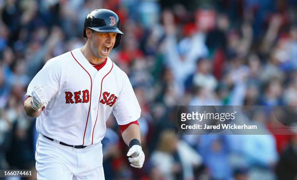 Daniel Nava of the Boston Red Sox celebrates while trotting around first base after hitting a three-run home run in the seventh inning off of Wei-Yin...
