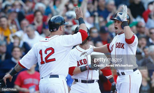 Daniel Nava of the Boston Red Sox celebrates with teammate Mike Napoli of the Boston Red Sox after hitting a three-run home run in the seventh inning...