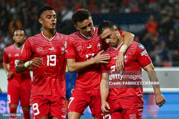 Switzerland's midfielder Xherdan Shaqiri celebrates with teammates after he shot a penalty and scored a third goal for his team during the UEFA Euro...