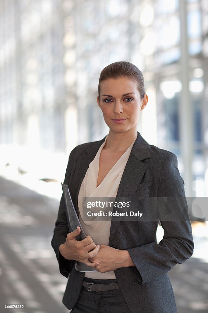 Portrait of smiling woman standing in corridor