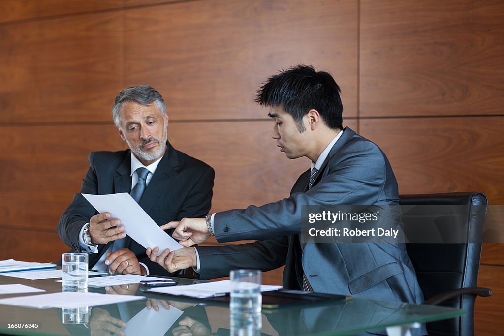 Businessmen signing paperwork