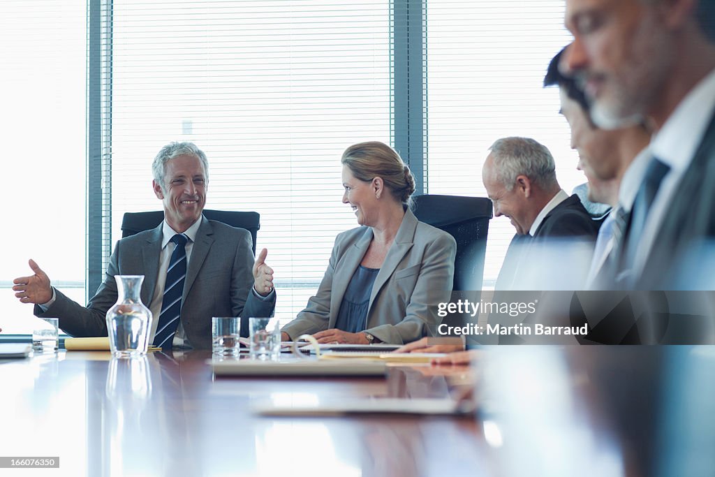 Business people watching presentation in conference room