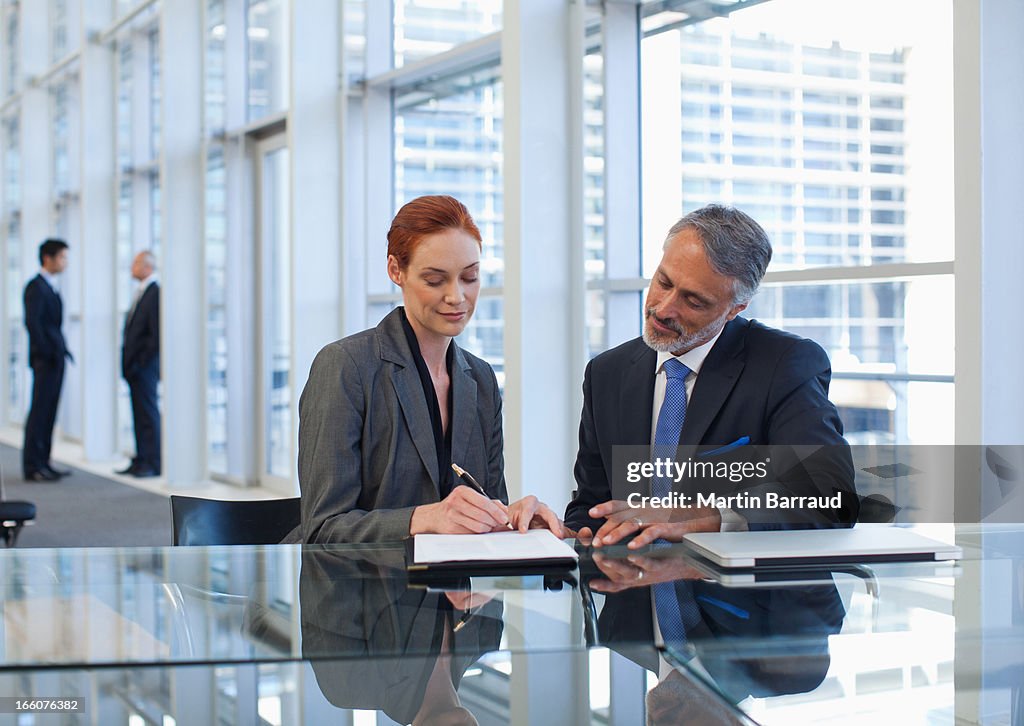 Business people talking in office lobby