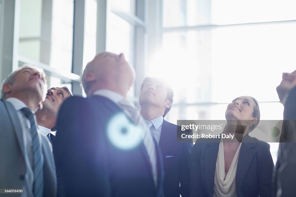 Business people looking up in lobby