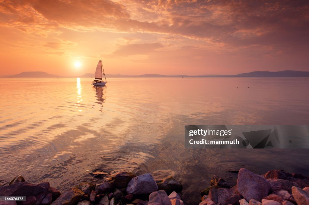 Sailboat on the lake at sunset.