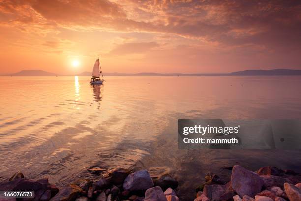 sailboat on the lake at sunset. - hungary summer stock pictures, royalty-free photos & images