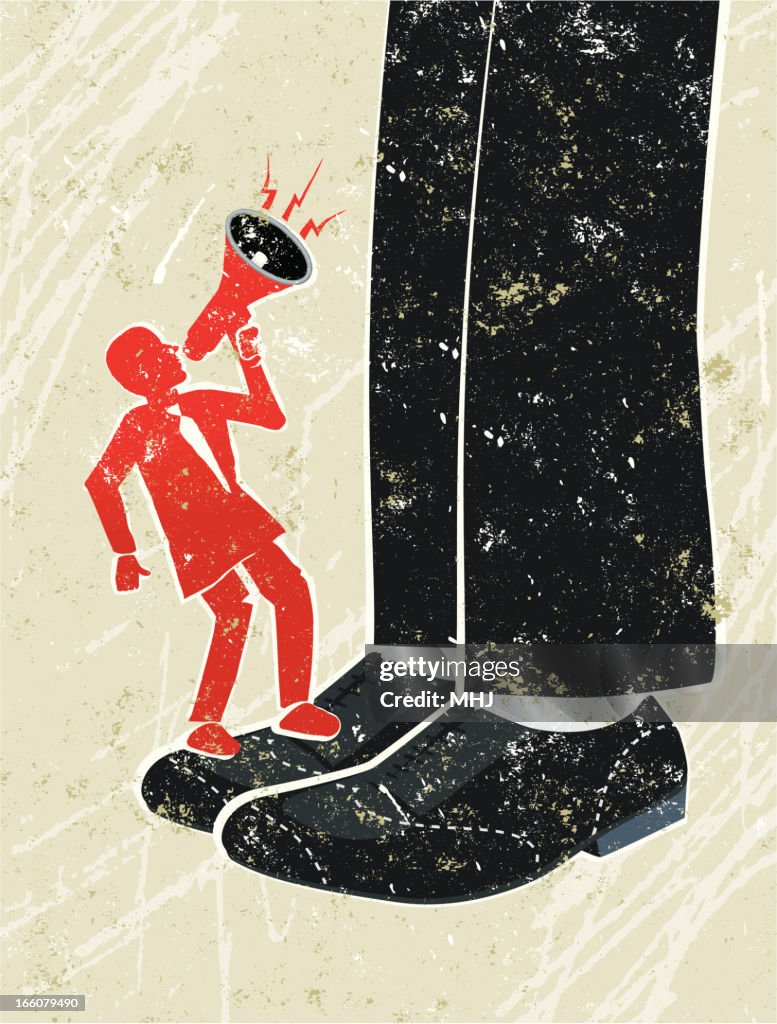 Tiny Business Man Shouting Through Megaphone at a Giant Businessman