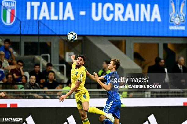 Ukraine's forward Roman Yaremchuk fights for the ball with Italy's defender Giorgio Scalvini during the Euro 2024 football tournament group C...