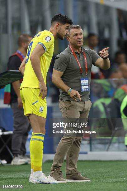 Head Coach Sergii Rebrov of Ukraine talks to Roman Yaremchuk of Ukraine during the UEFA EURO 2024 European qualifier match between Italy and Ukraine...