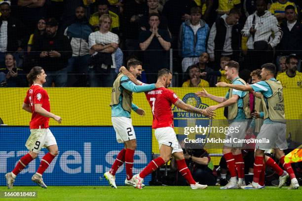 Marko Arnautovic of Austria celebrates with teammates after scoring the 0-3 goal during the UEFA EURO 2024 European qualifier match between Sweden...