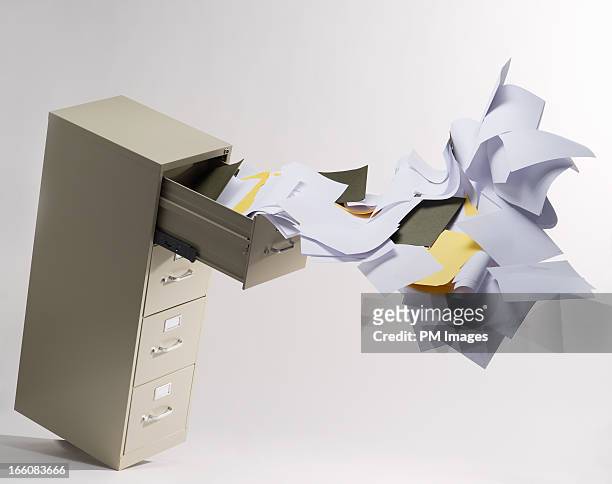 files flying out of file cabinet - paper furniture stockfoto's en -beelden