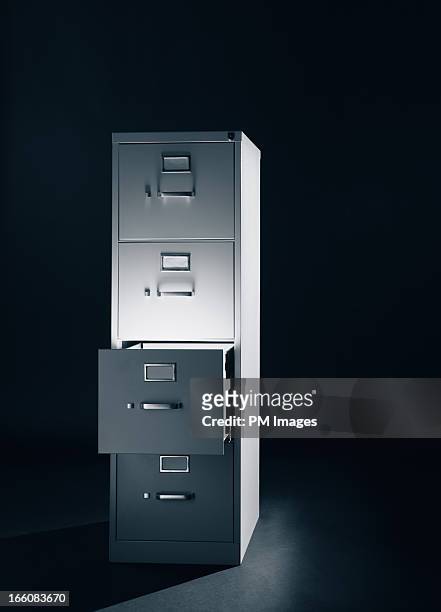 light from open file cabinet drawer - archivieren stock-fotos und bilder
