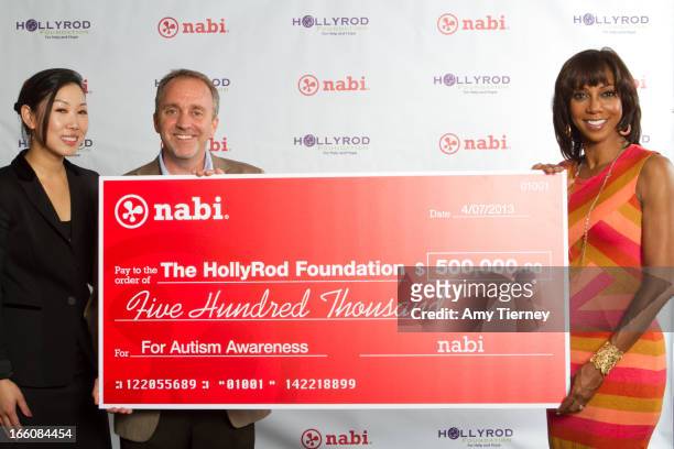 Lisa Lee, Director of Marketing and Communications, Fuhu Inc., Jim Mitchell, CEO of Fuhu Inc., and Holly Robinson Peete gather for a donation on...
