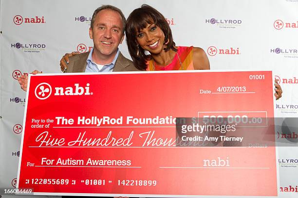 Jim Mitchell, CEO of Fuhu Inc., and Holly Robinson Peete gather for a donation on behalf of nabi to the HollyRod Foundation to help families living...