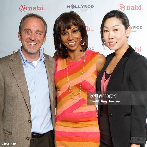 Jim Mitchell, CEO, Fuhu Inc., Holly Robinson Peete, and Lisa Lee, Director of Marketing and Communications, Fuhu Inc., gather for a donation on...