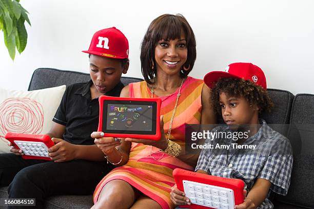 Rob Peete, Holly Robinson Peete and Roman Peete gather for a donation on behalf of nabi to the HollyRod Foundation to help families living with...