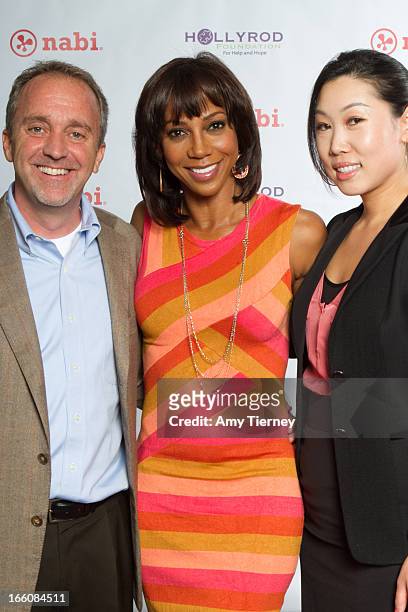Jim Mitchell, CEO, Fuhu Inc., Holly Robinson Peete, and Lisa Lee, Director of Marketing and Communications, Fuhu Inc., gather for a donation on...