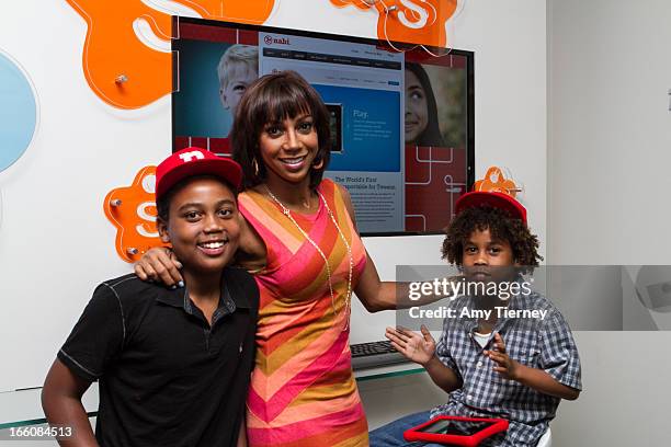 Rob Peete, Holly Robinson Peete, and Roman Peete gather for a donation on behalf of nabi to the HollyRod Foundation to help families living with...