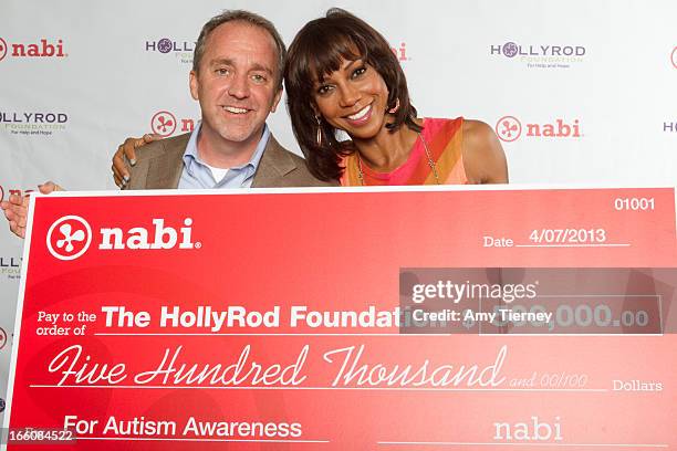 Jim Mitchell, CEO of Fuhu Inc., and Holly Robinson Peete gather for a donation on behalf of nabi to the HollyRod Foundation to help families living...