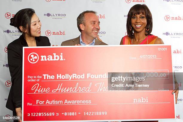 Lisa Lee, Director of Marketing and Communications, Fuhu Inc., Jim Mitchell, CEO Fuhu Inc., and Holly Robinson Peete gather for a donation on behalf...