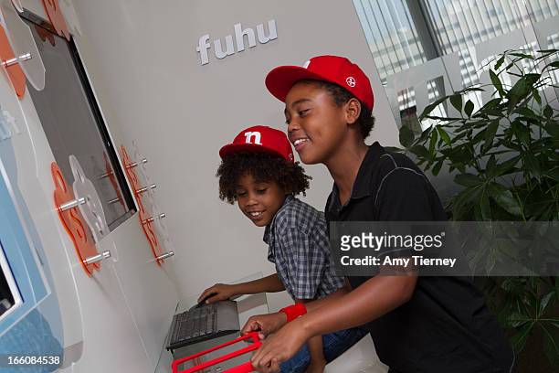 Roman Peete and Rob Peete gather for a donation on behalf of nabi to the HollyRod Foundation to help families living with autism at Fuhu, Inc. On...