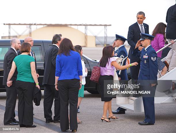 President Barack Obama conduct family members of Newtown shooting victims to board Air Force One before departing from Bradley Air National Guard...