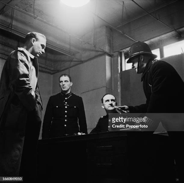 Policemen from the Metropolitan Police in the process of charging a suspect in the Charge Room at West End Central Police Station at 27 Savile Row in...
