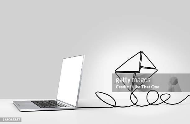 laptop computer with cable forming a n envelope - e mail imagens e fotografias de stock