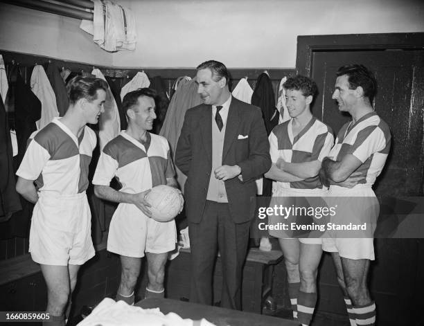 Bert Tann , manager of Bristol Rovers FC, talking with four of his players in the changing room, December 12th 1959.