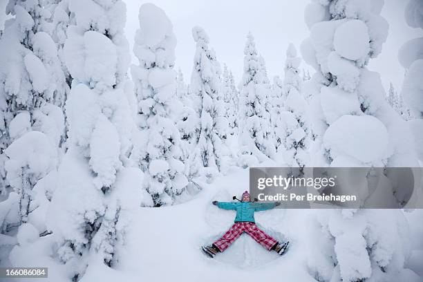 a perfect snow angel in a snowy forest - snow angel stock pictures, royalty-free photos & images