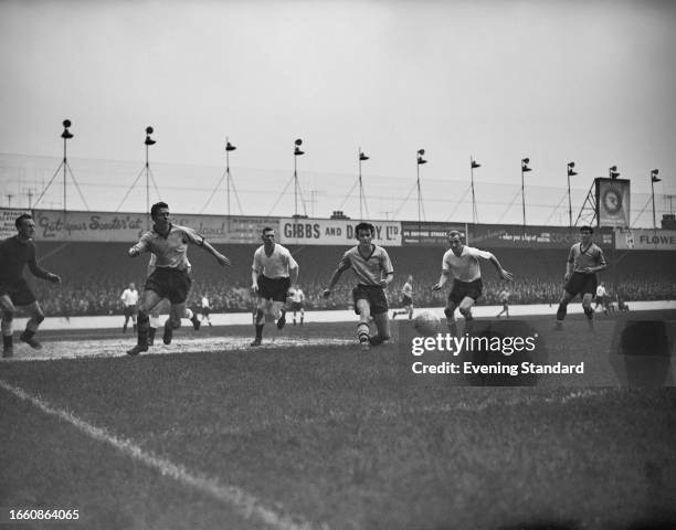 Seamus Dunne of Luton Town FC and Wolverhampton Wanderers' Bobby Mason and Jimmy Murray in action during a match at Kenilworth Road stadium, Luton,...