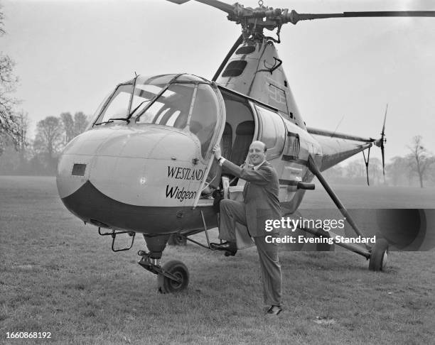 John Scott-Ellis, 9th Baron Howard de Walden , boarding a Westland Widgeon helicopter, April 25th 1960.