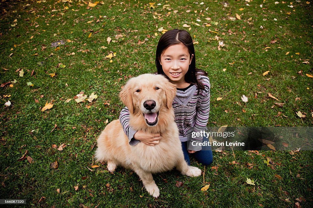 Young girl and pet golden retriever, portrait