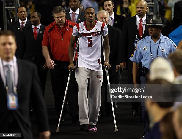 Injured guard Kevin Ware of the Louisville Cardinals walks out to the court against the Michigan Wolverines during the 2013 NCAA Men's Final Four...