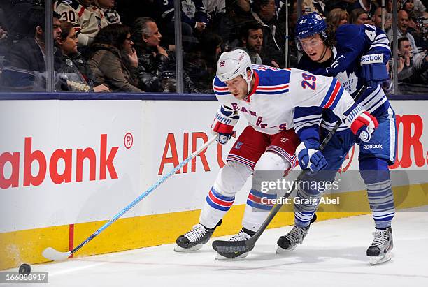 Tyler Bozak of the Toronto Maple Leafs battles for the puck with Ryane Clowe of the New York Rangers during NHL game action April 8, 2013 at the Air...