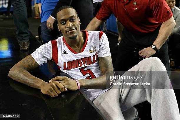 Injured guard Kevin Ware of the Louisville Cardinals leans on the court as the Cardinals get set to play against the Michigan Wolverines during the...