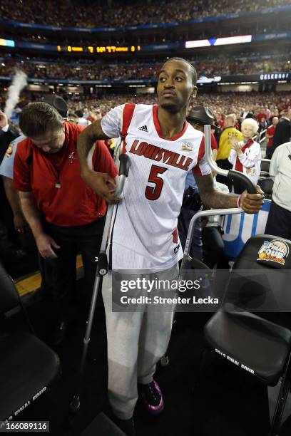 Injured guard Kevin Ware of the Louisville Cardinals walks out to the court against the Michigan Wolverines during the 2013 NCAA Men's Final Four...